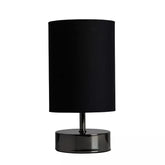 Matt Black Cylinder Touch Dimmer Table Lamp with black fabric shade on a bedside table.